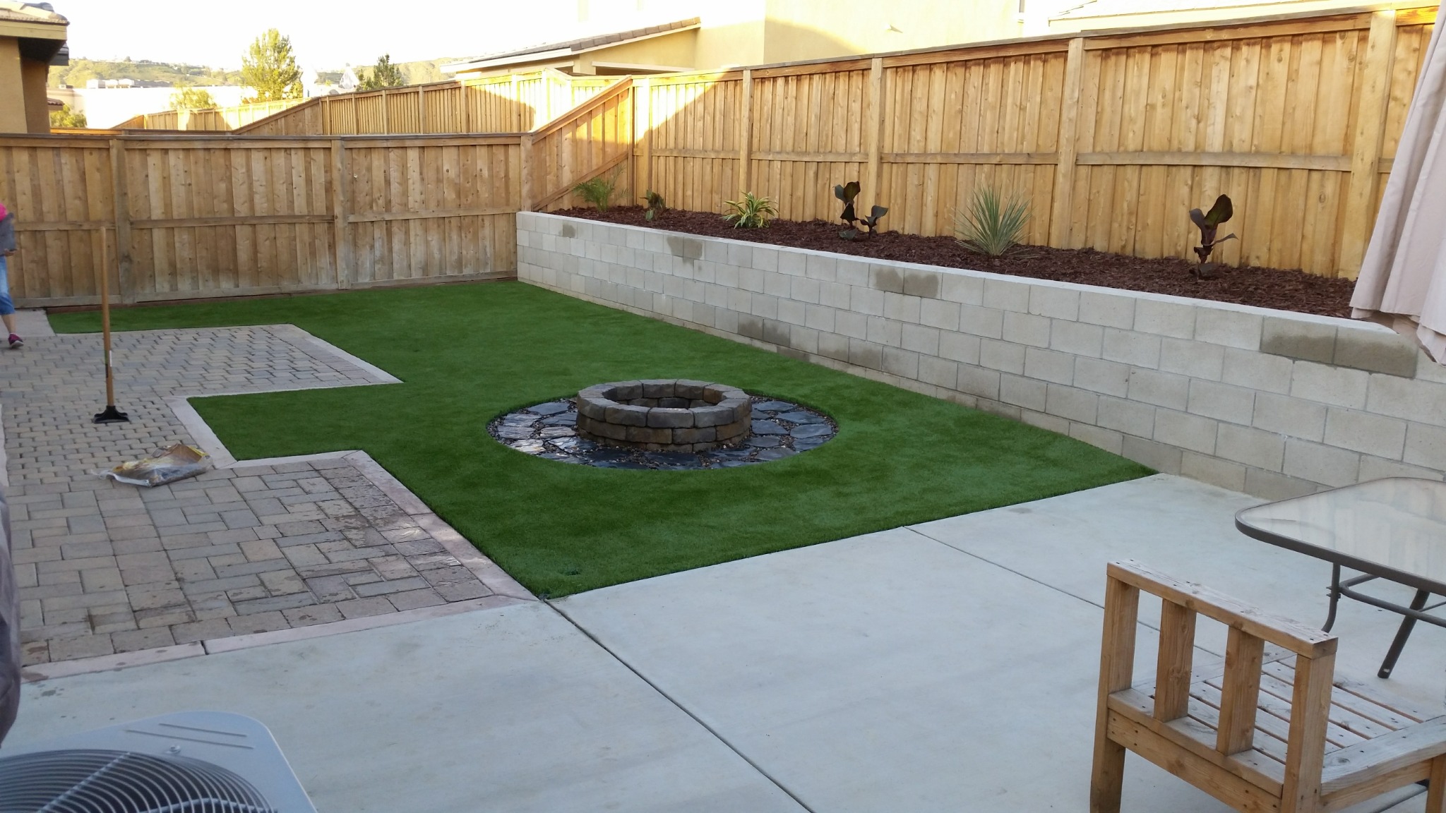 Completed stackable block fire pit installation in a backyard