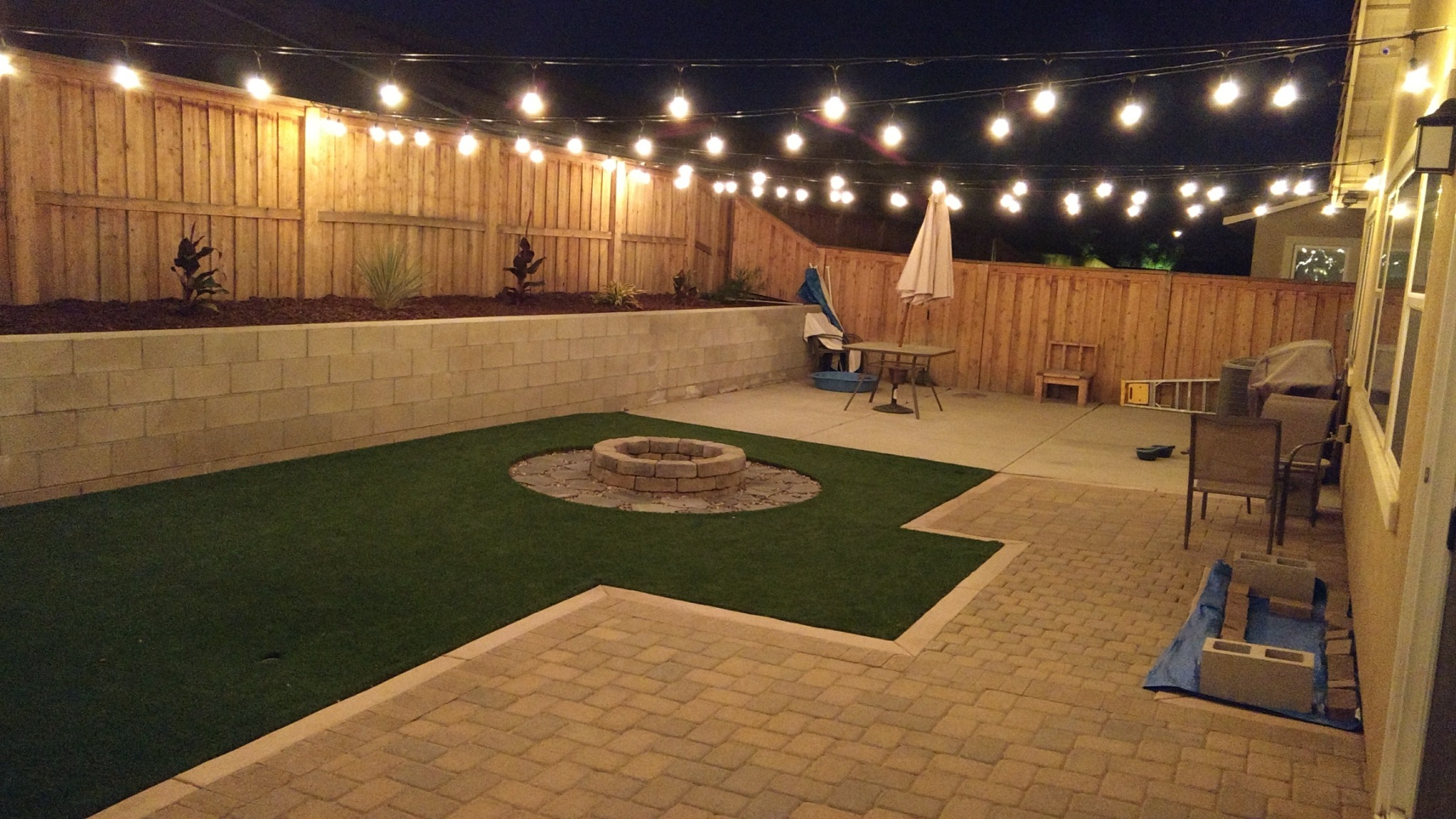 Completed backyard fire pit shown in the evening