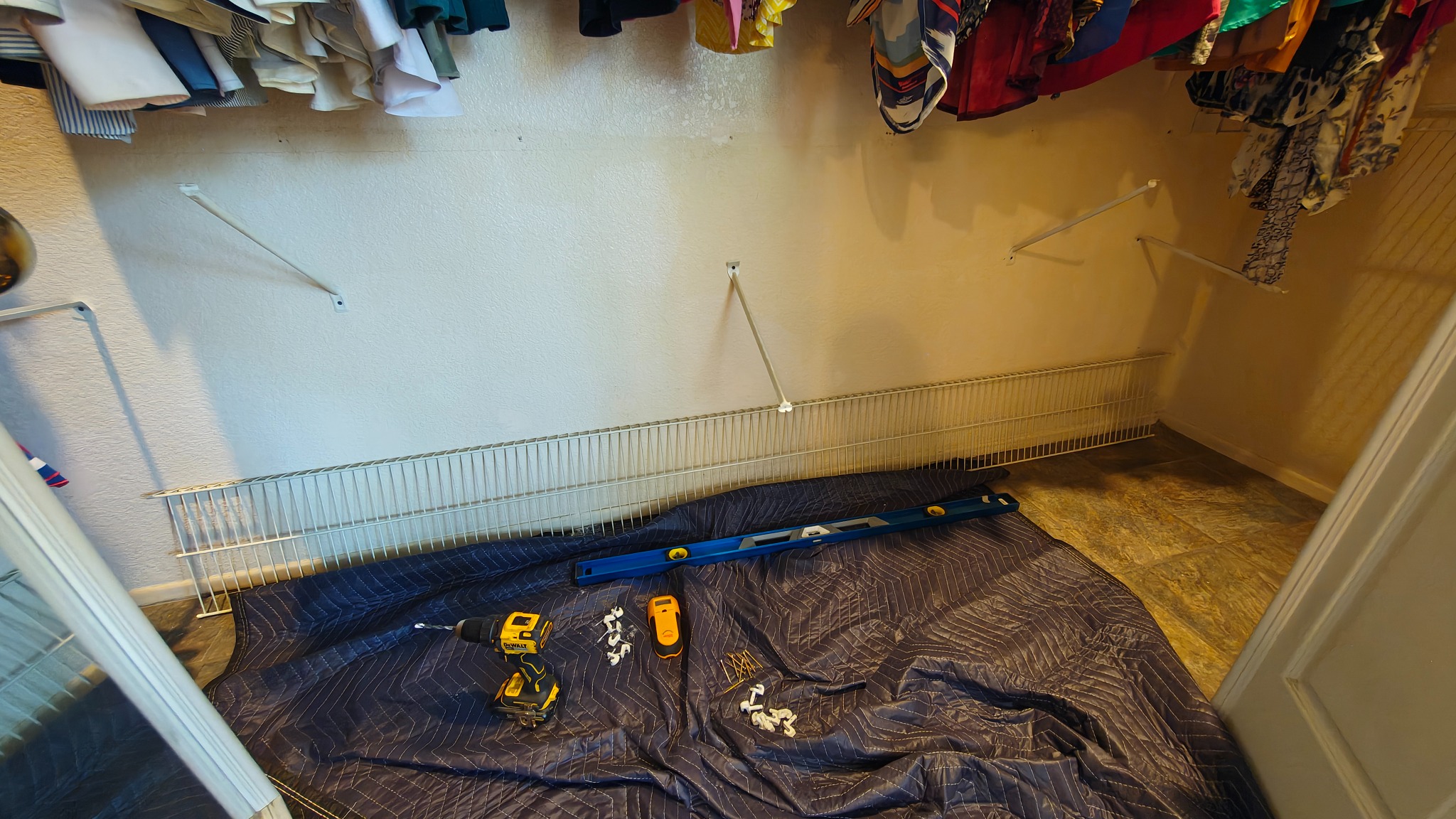 Collapsed wire shelving system in a master closet before repair