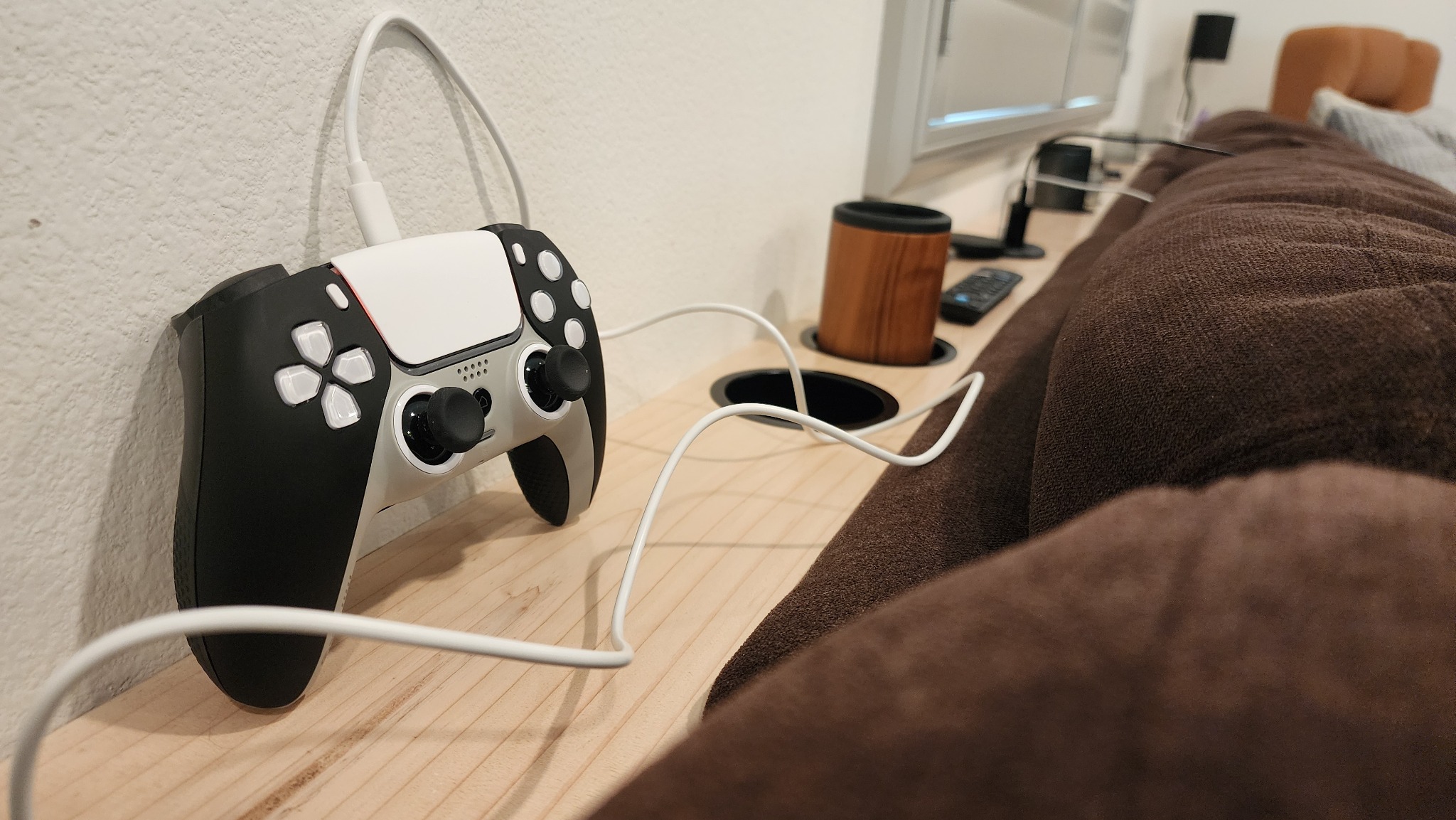 Game controller charging beside a custom console table