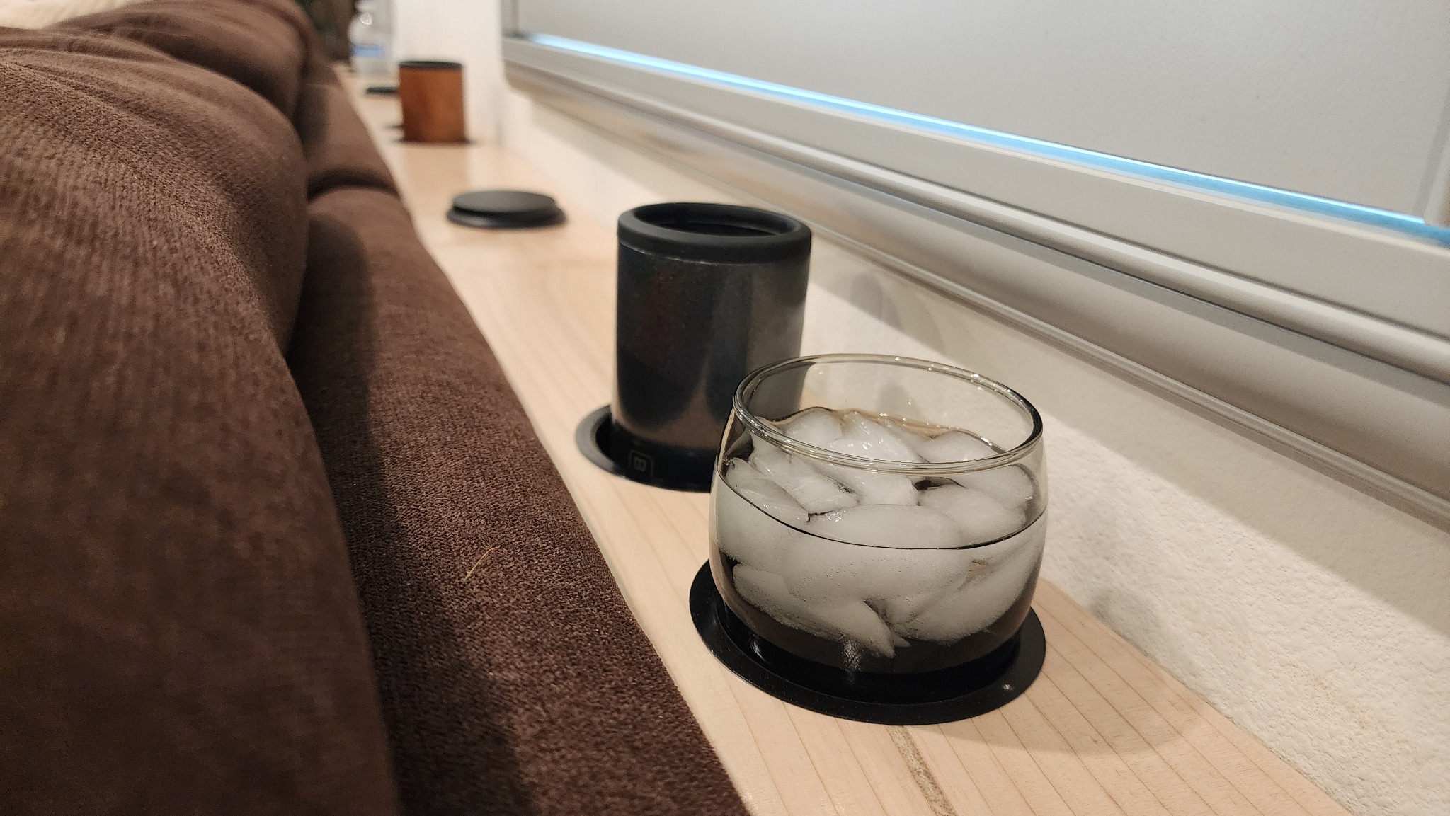 Cupholders built into a custom behind-the-couch console table