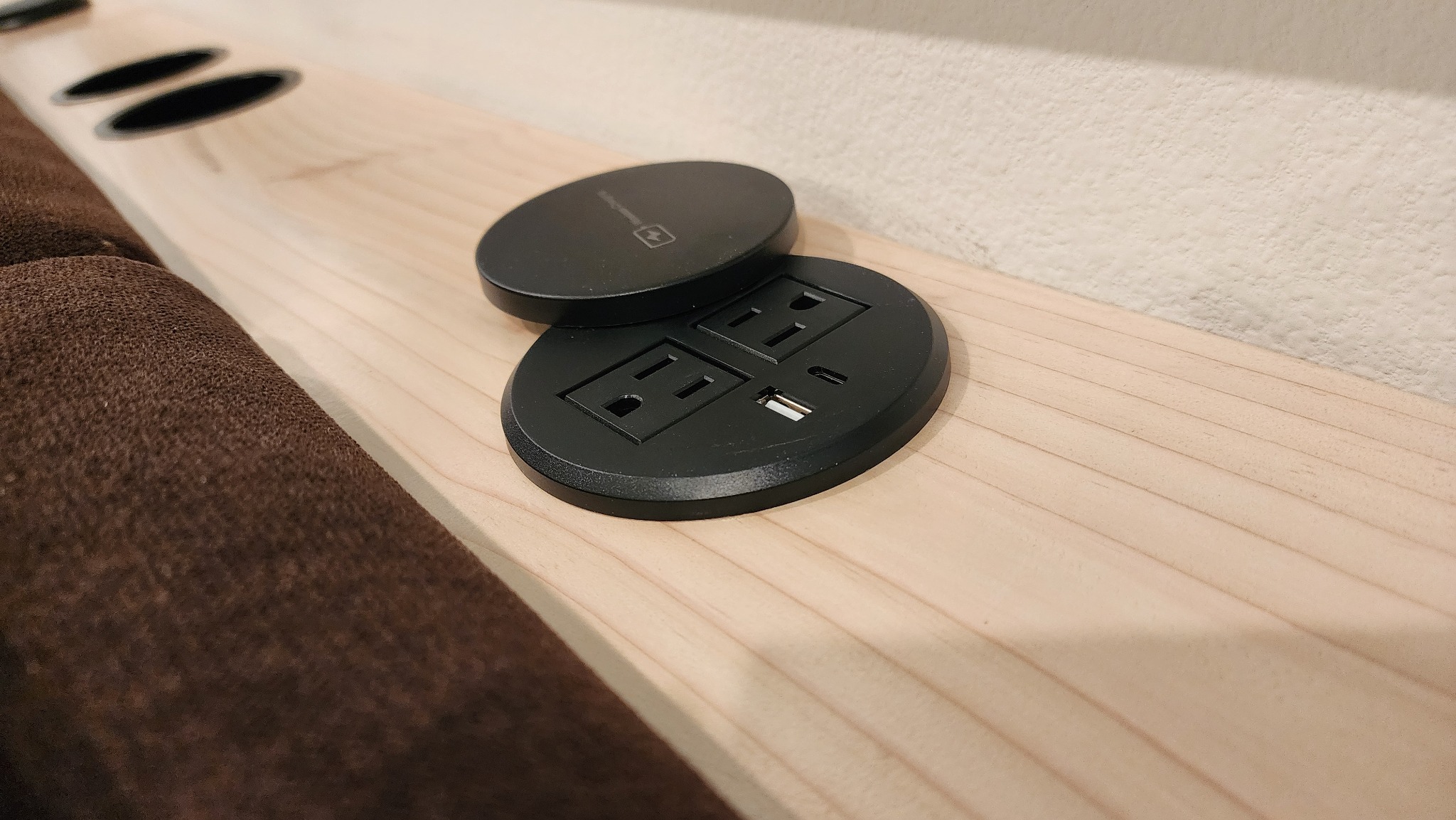 Integrated outlets and USB charging in a custom behind-the-couch table