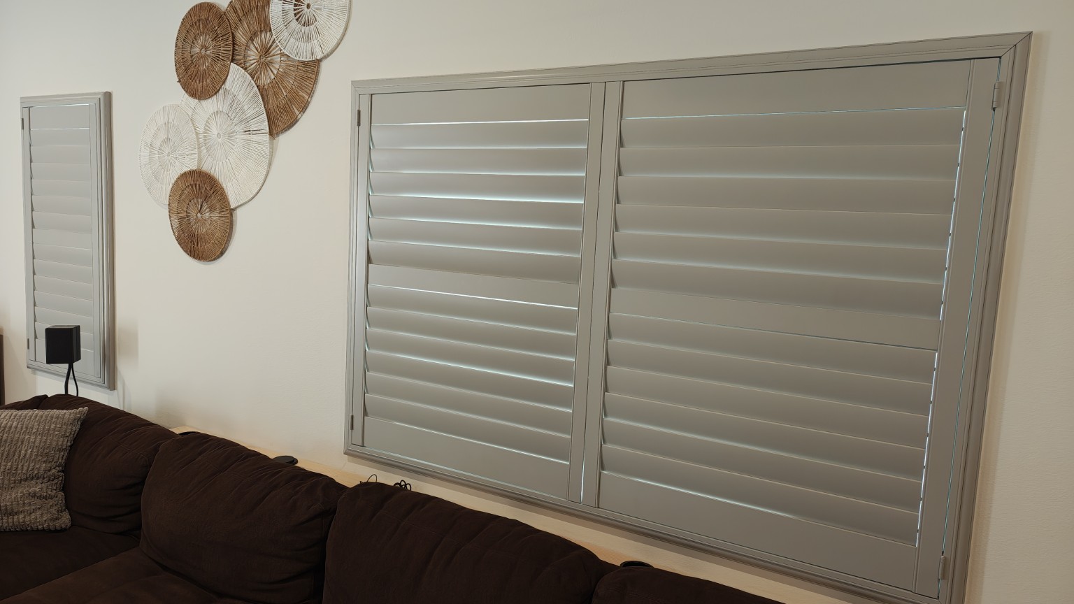 Custom plantation shutters installed on large and narrow family-room windows