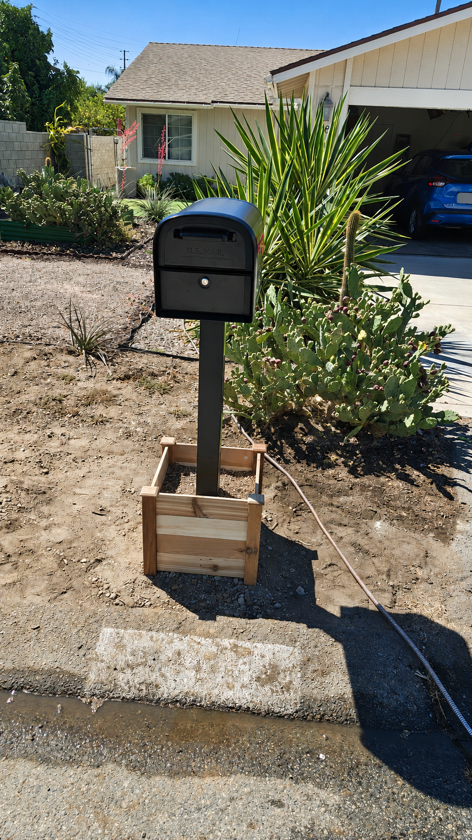 Completed black locking mailbox and post installation