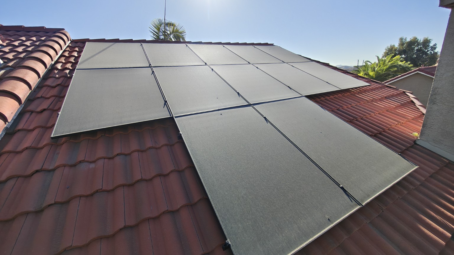 Two-story rooftop solar panels before professional cleaning
